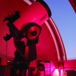 a telescope in a room with a window