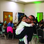 Father holds daughter at father-daughter dance